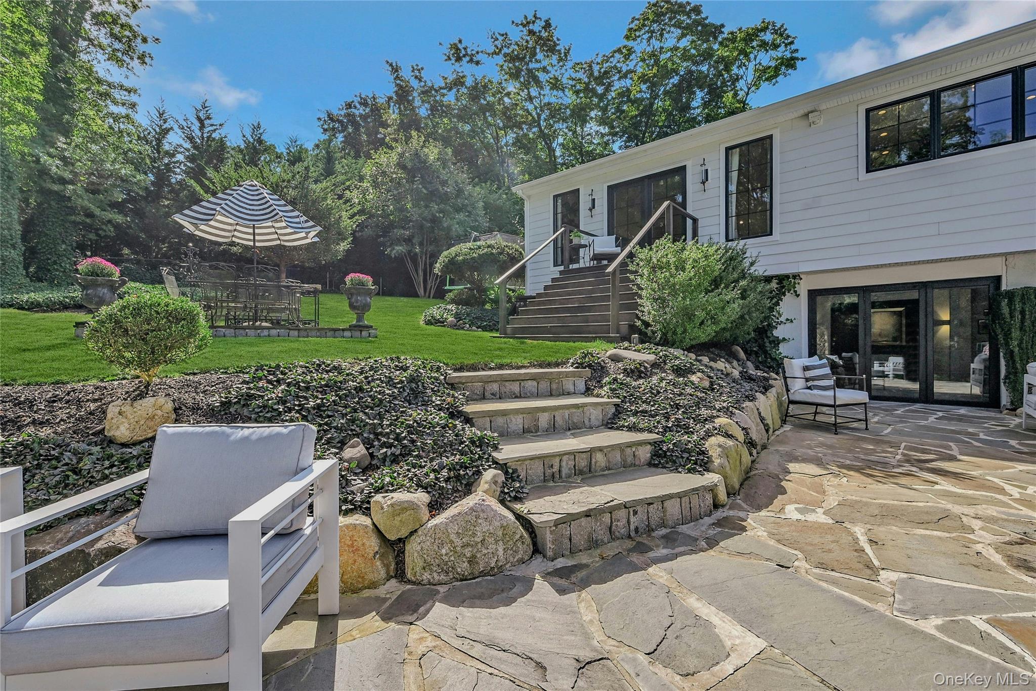 262 Huntington Bay Road Huntington Bay, NY 11743 - Photo 29 of 39 a view of a house with backyard sitting area and garden