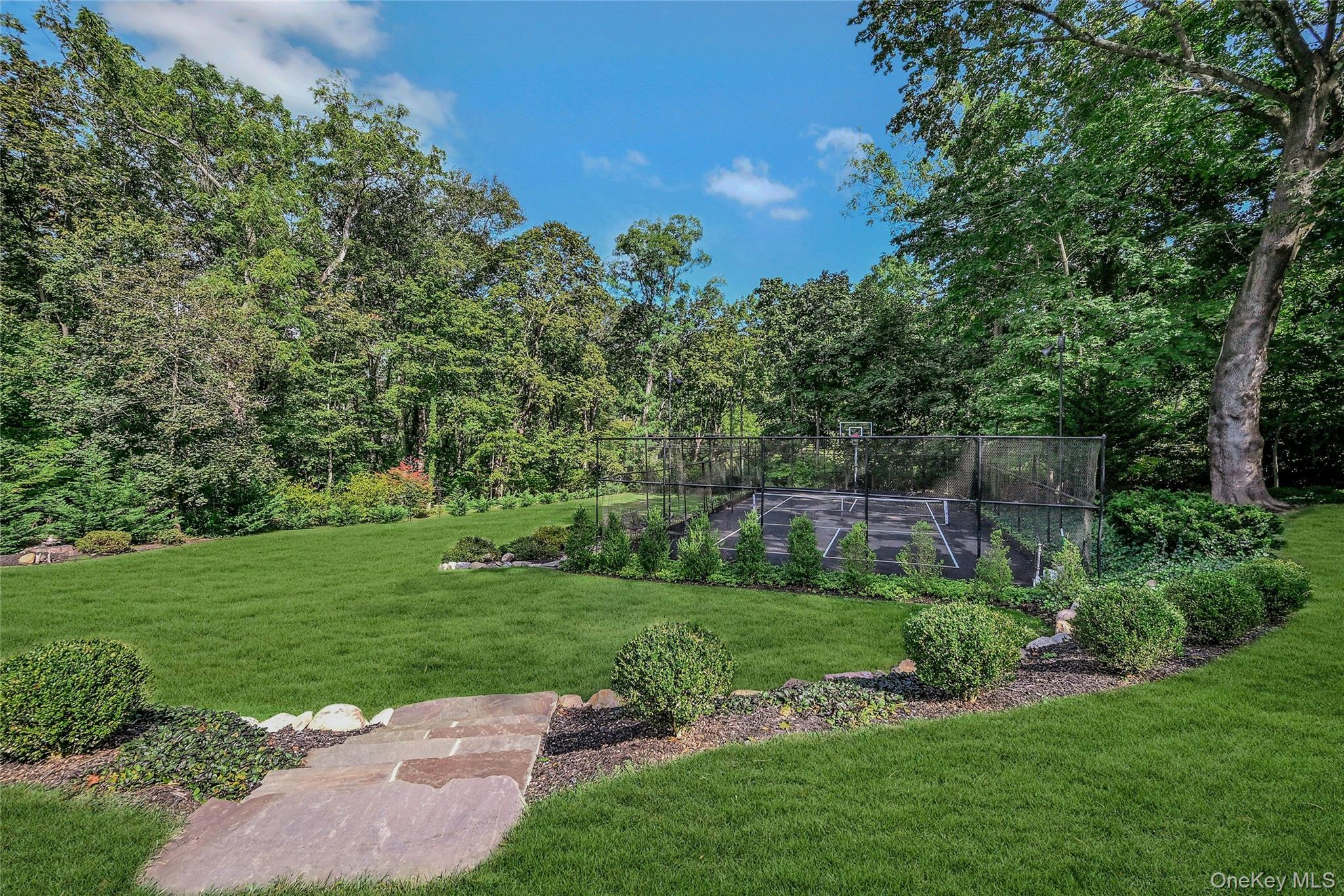 262 Huntington Bay Road Huntington Bay, NY 11743 - Photo 30 of 39 a view of a garden with a building in the background