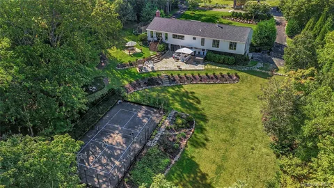 a view of a house with a yard and garden