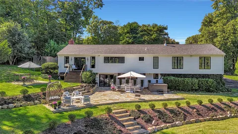 a view of a house with swimming pool and a yard