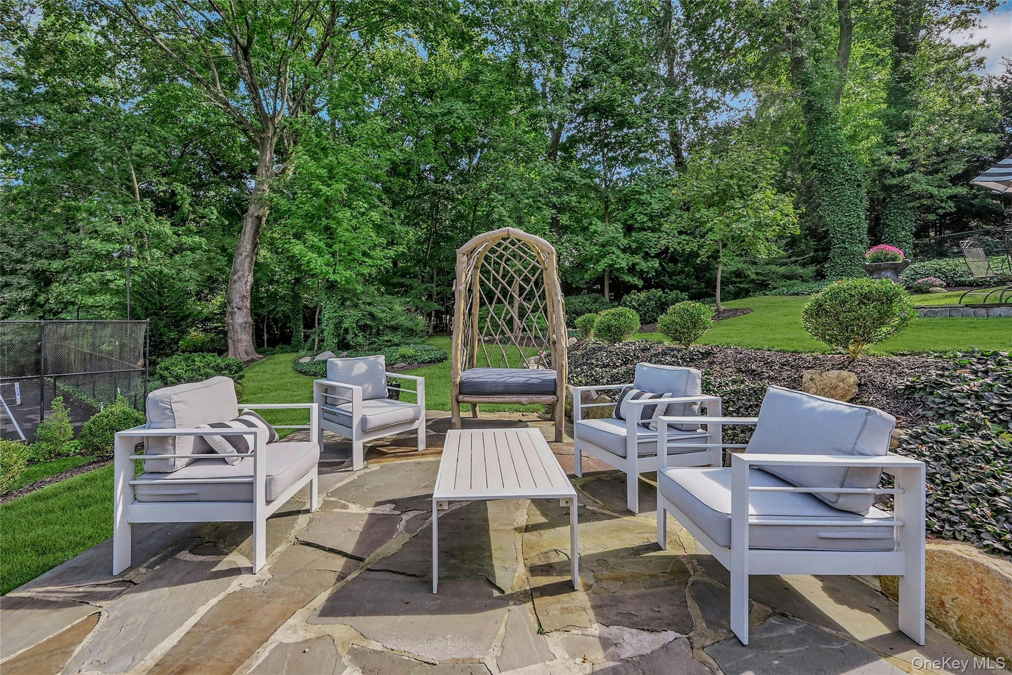 262 Huntington Bay Road Huntington Bay, NY 11743 - Photo 34 of 39 a view of a chairs and table in backyard of the house