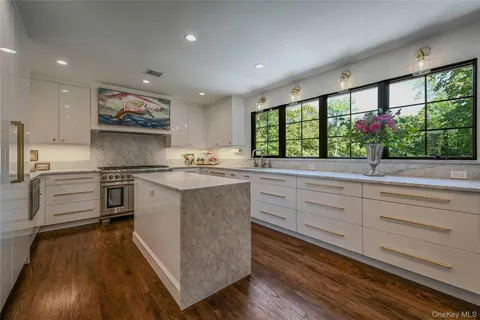 a kitchen with granite countertop kitchen island and white cabinets