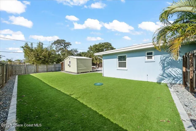 a view of a backyard with plants and a garden
