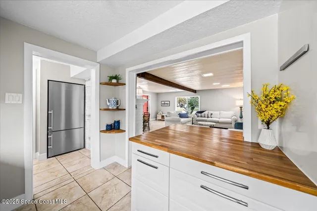 a kitchen with stainless steel appliances granite countertop a refrigerator and a stove