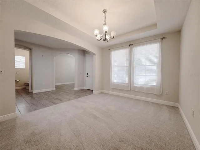 a large kitchen with a large counter top stainless steel appliances and cabinets