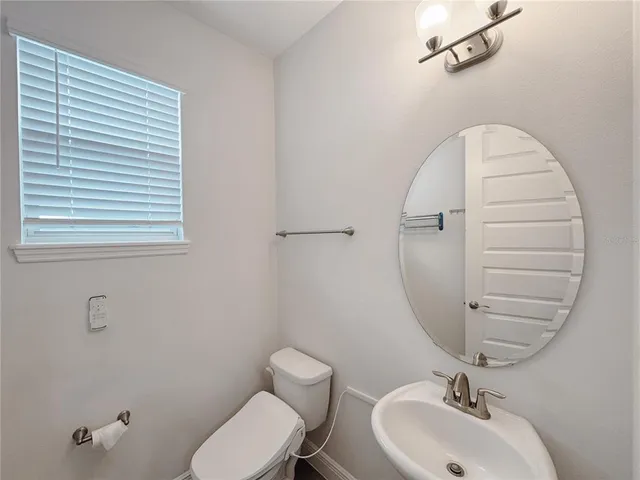 an empty room with wooden floor closet and windows