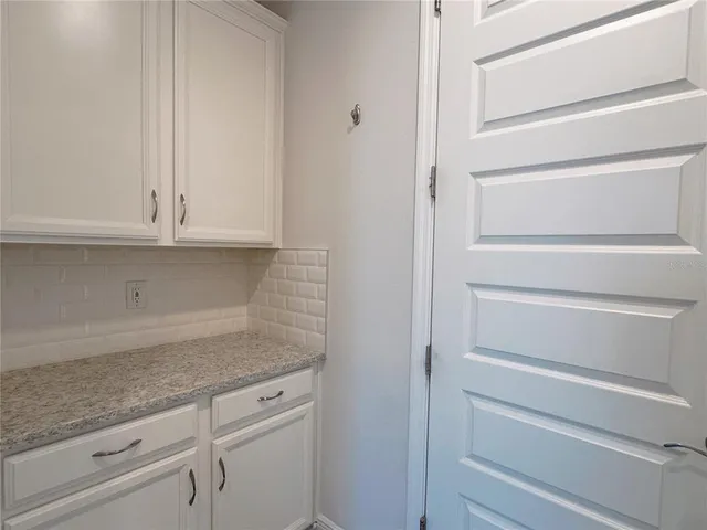a bathroom with a granite countertop sink vanity mirror and a