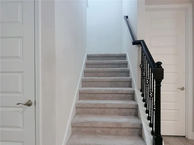 a front view of a house with a garden and garage