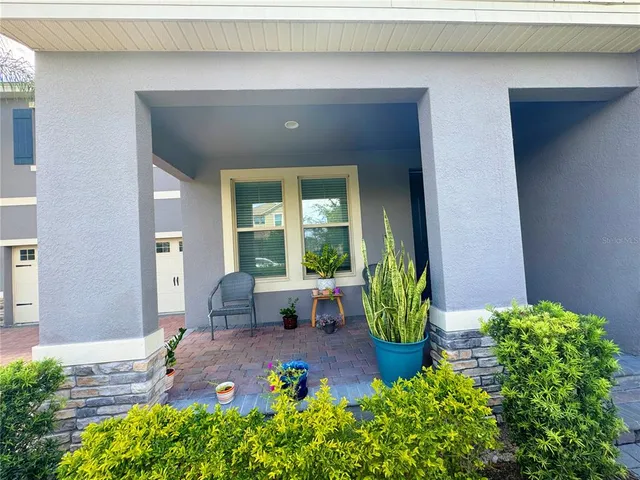 a kitchen with granite countertop a refrigerator oven a sink dishwasher and white cabinets with wooden floor