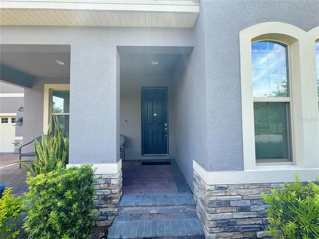 a kitchen with granite countertop white cabinets and a stove