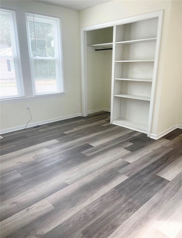 208 Hampton Street Iva, SC 29655 - Photo 7 of 19 This bright room features a built-in bookshelf, offering practical storage solutions.
