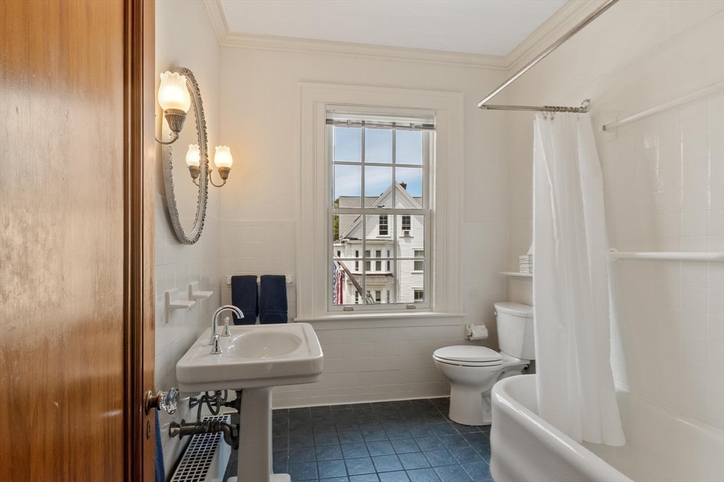 89 Lothrop Street Beverly, MA 01915 - Photo 37 of 41 a bathroom with a toilet a sink and a mirror