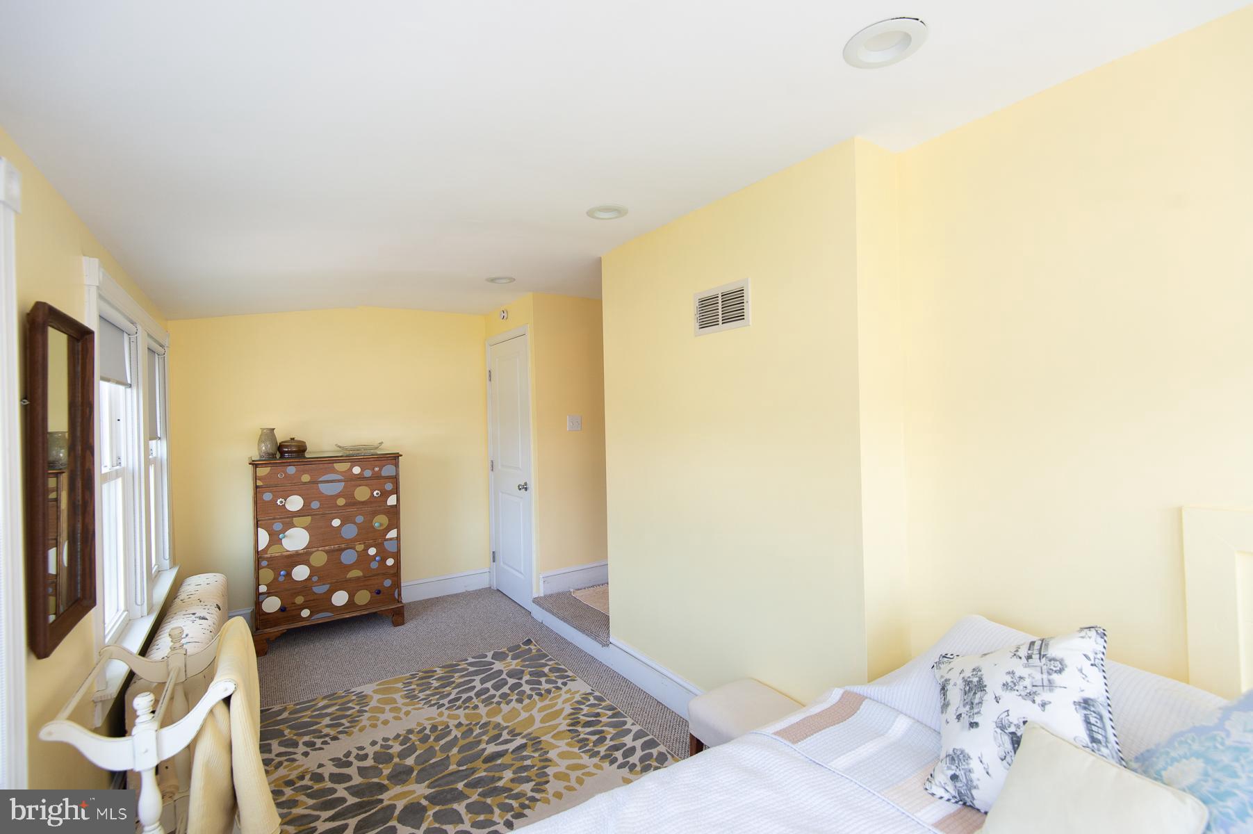 606 Locust Street Cambridge, MD 21613 - Photo 24 of 37 a bedroom with a bed and wooden floor