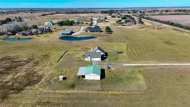 an aerial view of residential houses with outdoor space