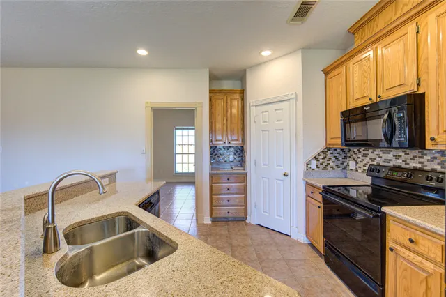 a kitchen with a sink and a stove top oven