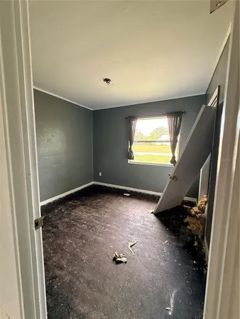 a view of an empty room and a window