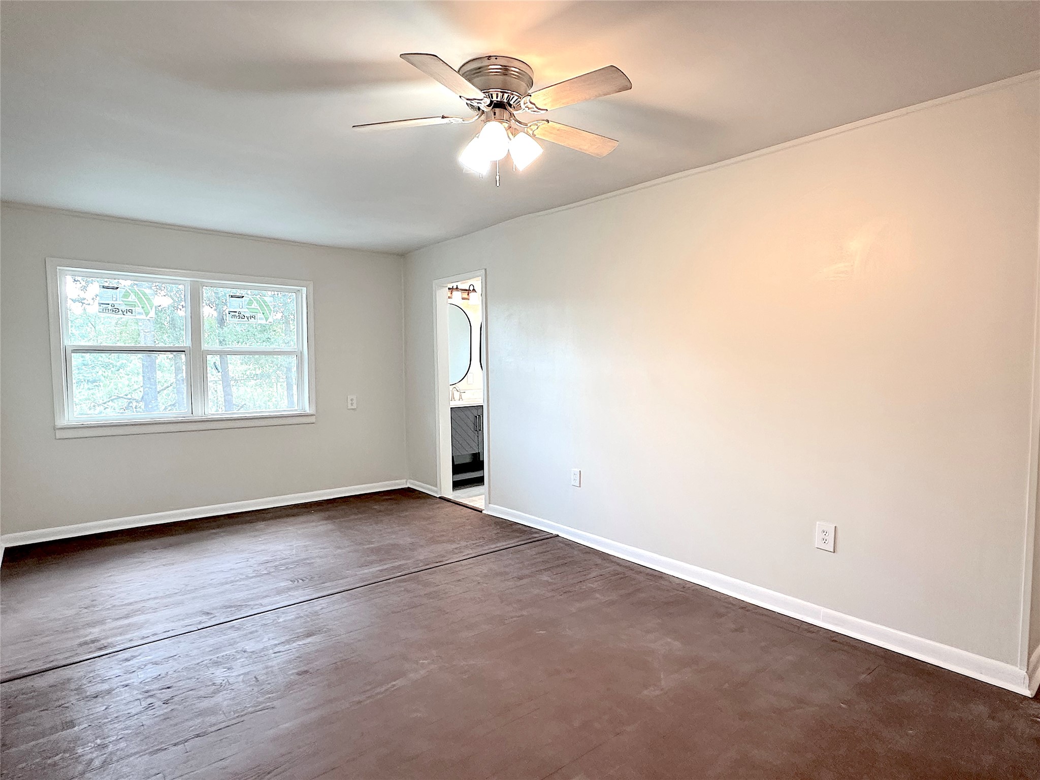 24254 Jane Avenue Porter, TX 77365 - Photo 12 of 26 an empty room with chandelier fan and windows