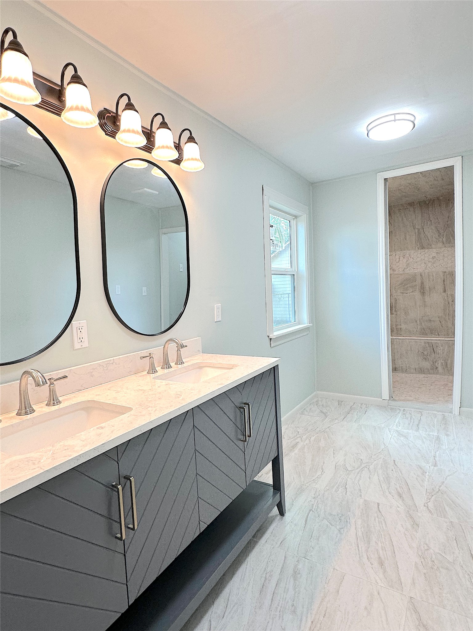 24254 Jane Avenue Porter, TX 77365 - Photo 13 of 26 a bathroom with a double vanity sink and a mirror