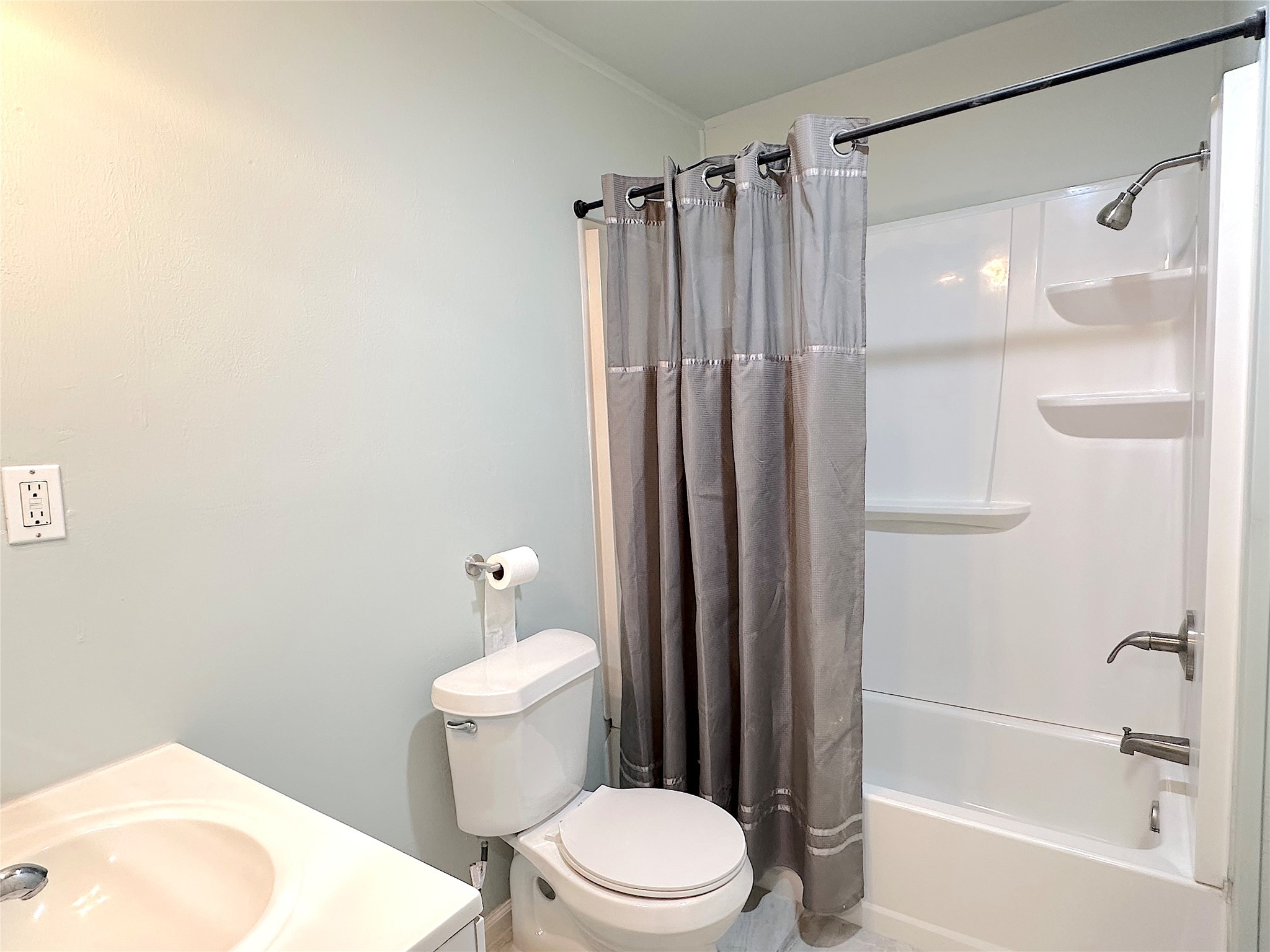 24254 Jane Avenue Porter, TX 77365 - Photo 17 of 26 a white toilet and shower sitting next to a bathroom sink