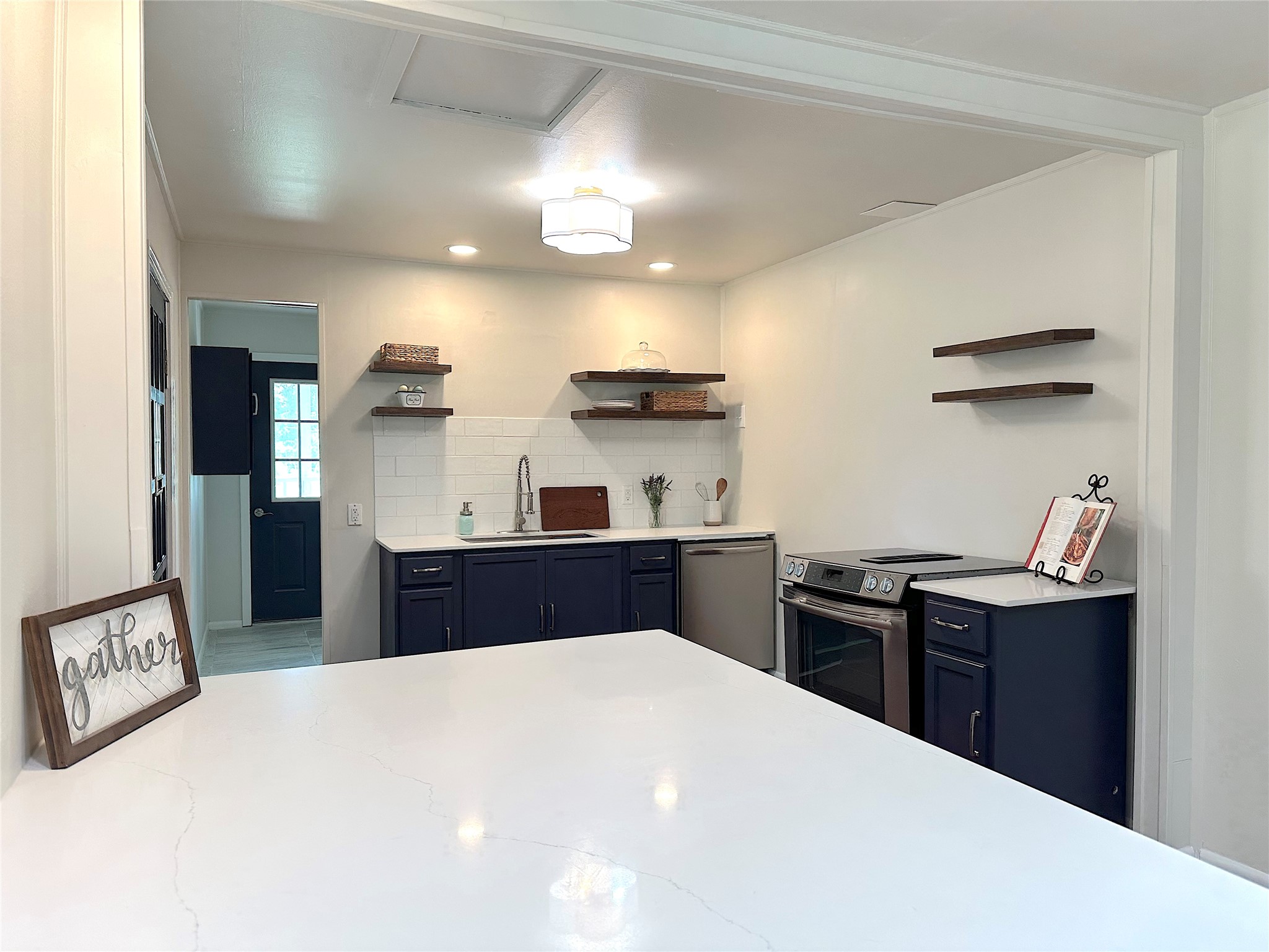 24254 Jane Avenue Porter, TX 77365 - Photo 2 of 26 a kitchen with stainless steel appliances kitchen island granite countertop a sink stove and refrigerator