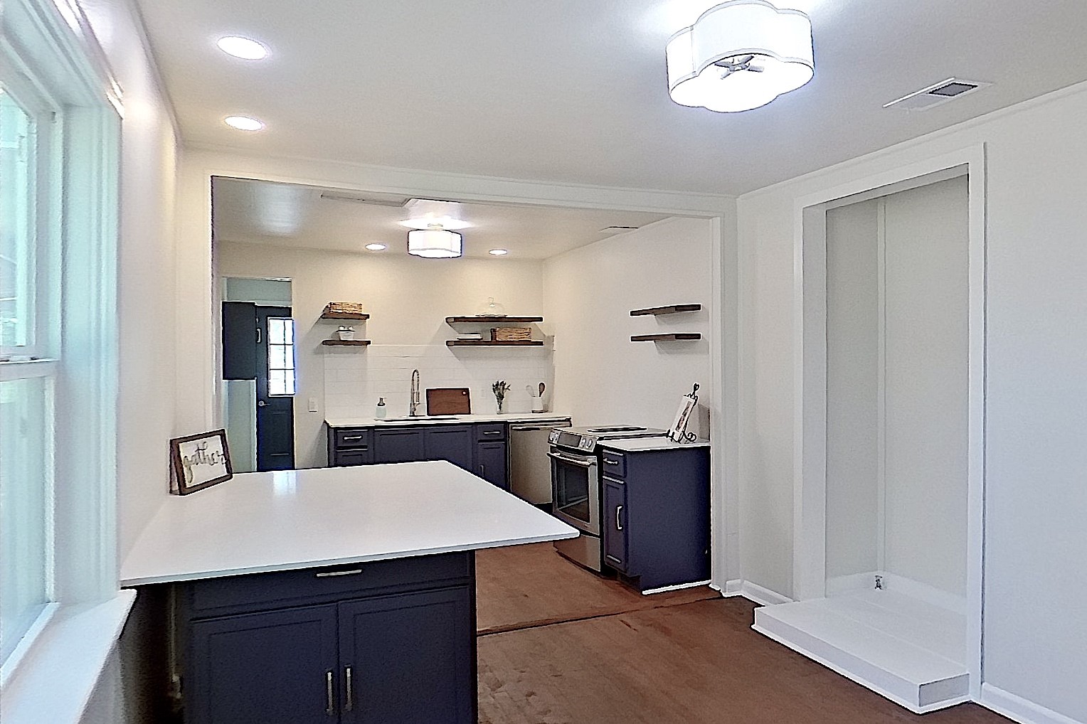24254 Jane Avenue Porter, TX 77365 - Photo 4 of 26 a kitchen with stainless steel appliances kitchen island granite countertop a refrigerator a sink dishwasher with a dining table and chairs
