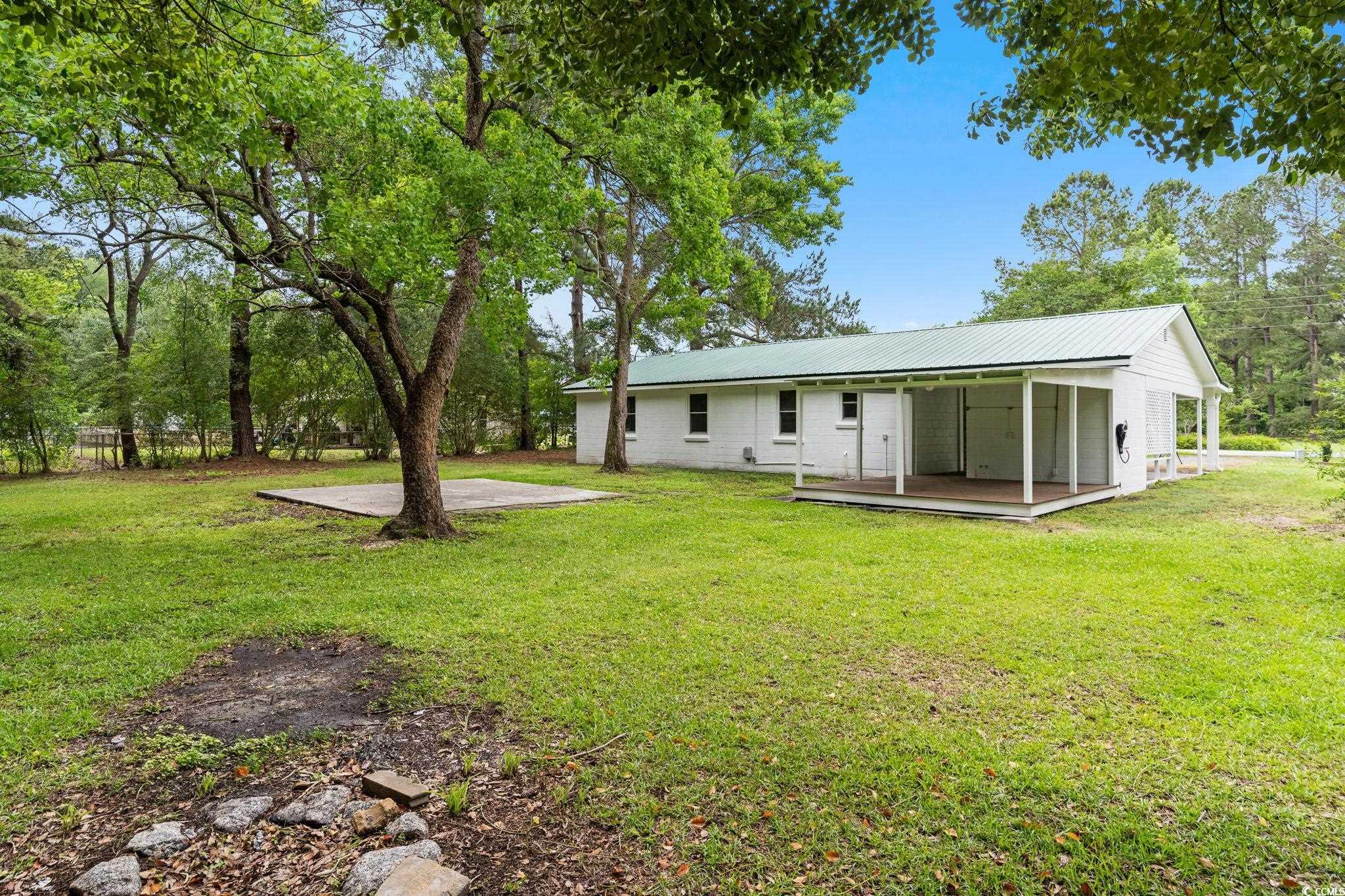 96 Middleton Road Andrews, SC 29510 - Photo 12 of 40 Rear view of property featuring metal roof, a lawn