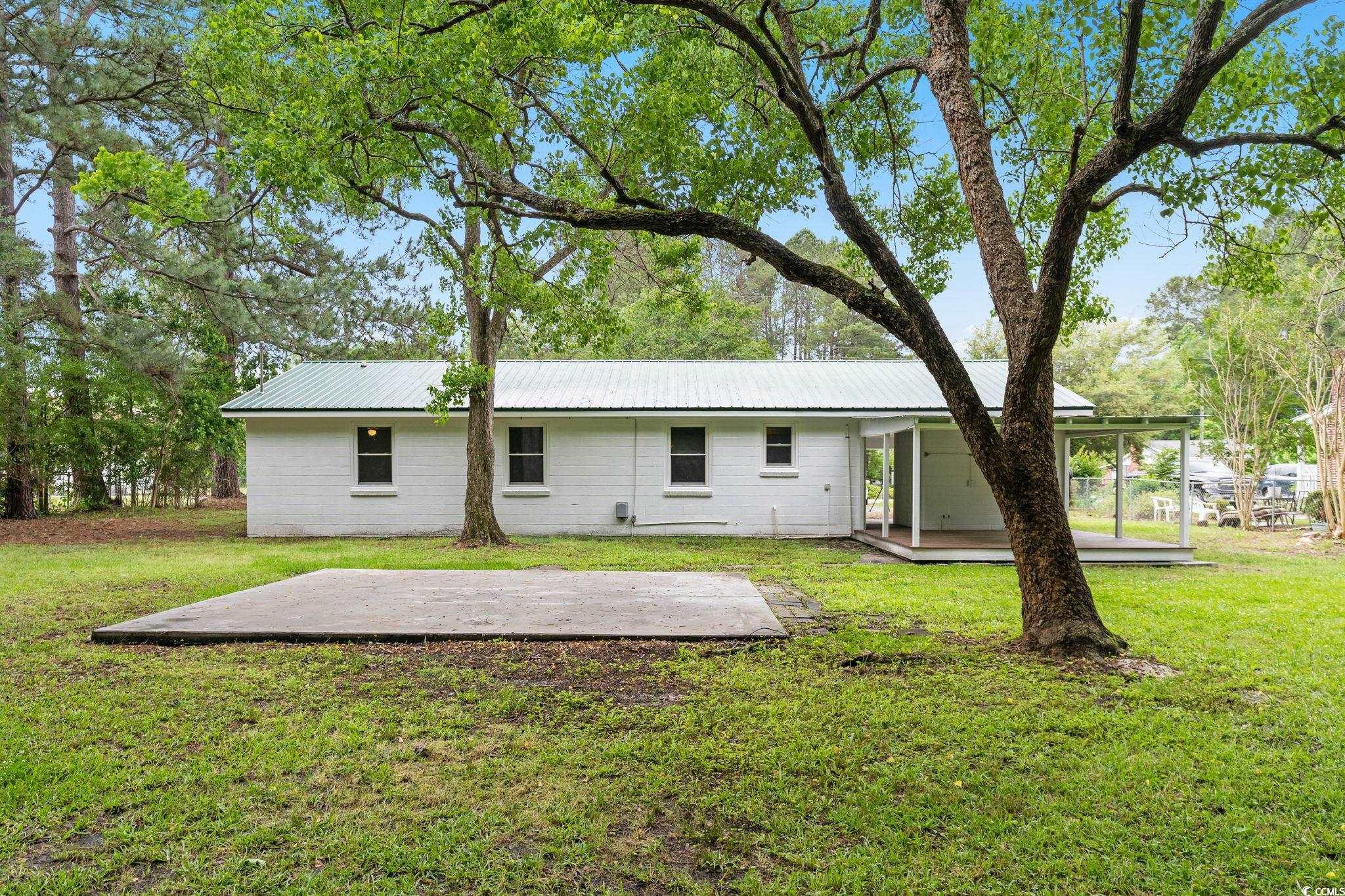 96 Middleton Road Andrews, SC 29510 - Photo 14 of 40 Back of house with a patio, a lawn, metal roof, an
