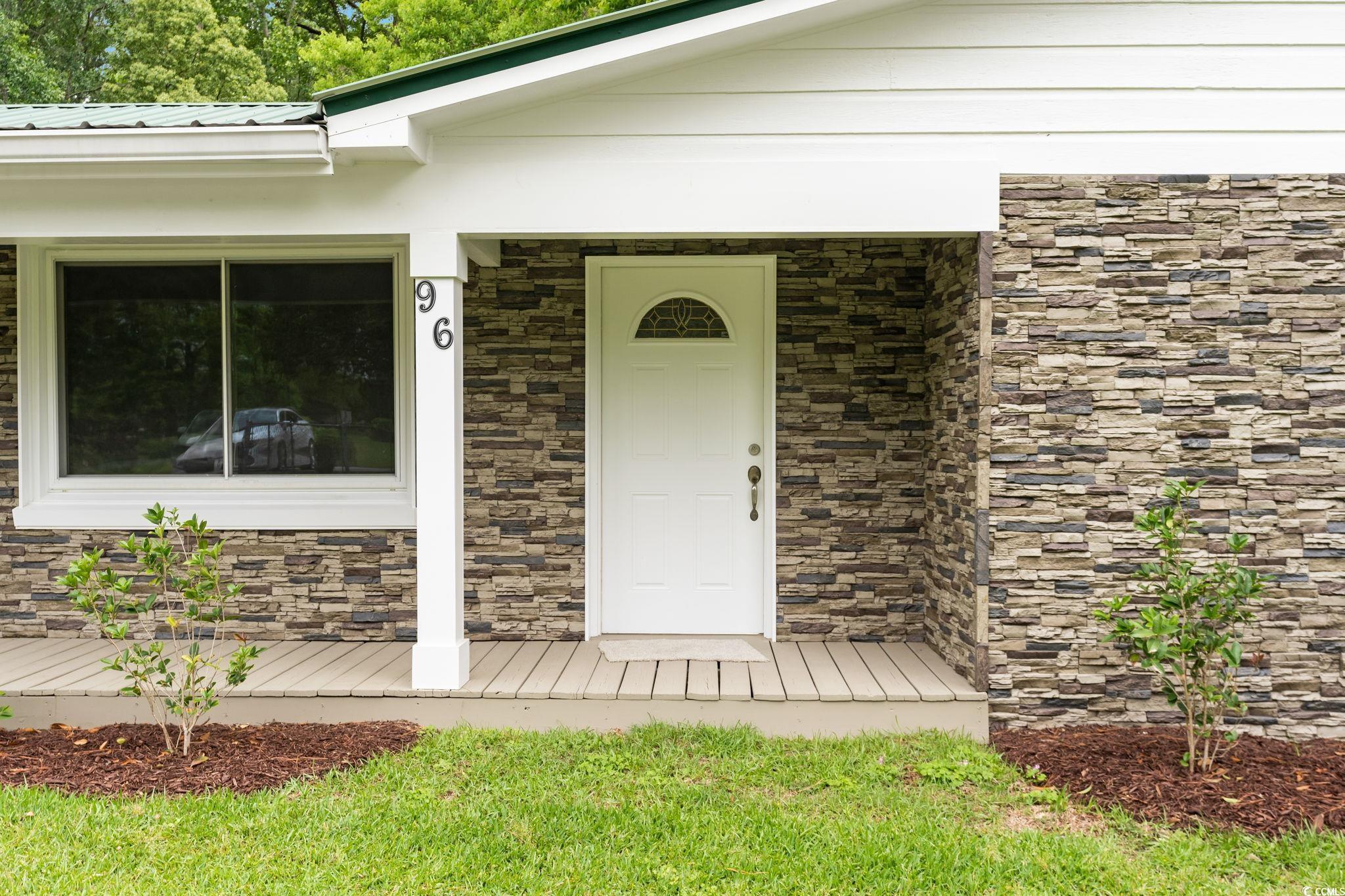 96 Middleton Road Andrews, SC 29510 - Photo 17 of 40 Doorway to property featuring stone siding and met