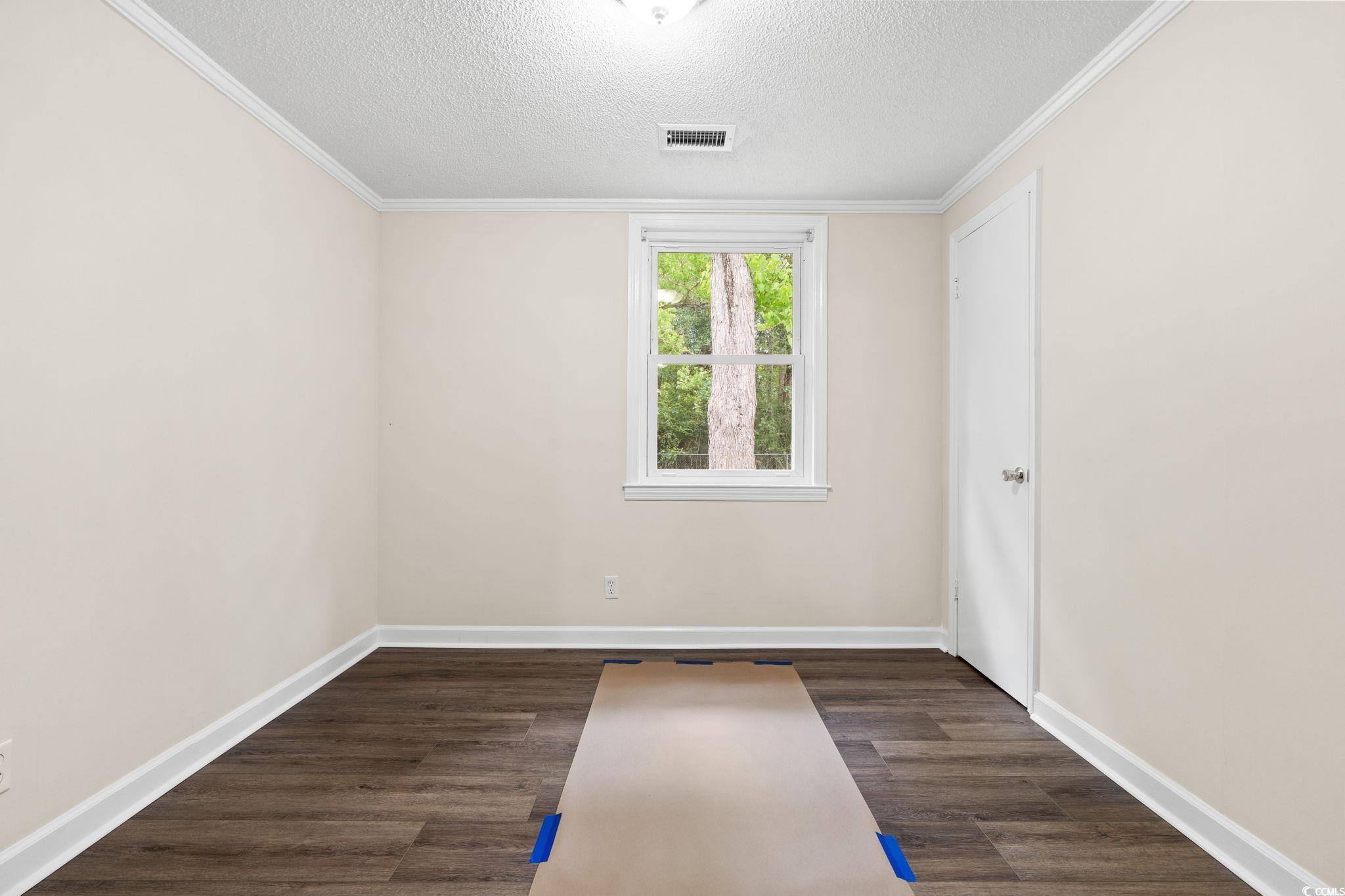 96 Middleton Road Andrews, SC 29510 - Photo 34 of 40 Empty room featuring a textured ceiling, wood fini