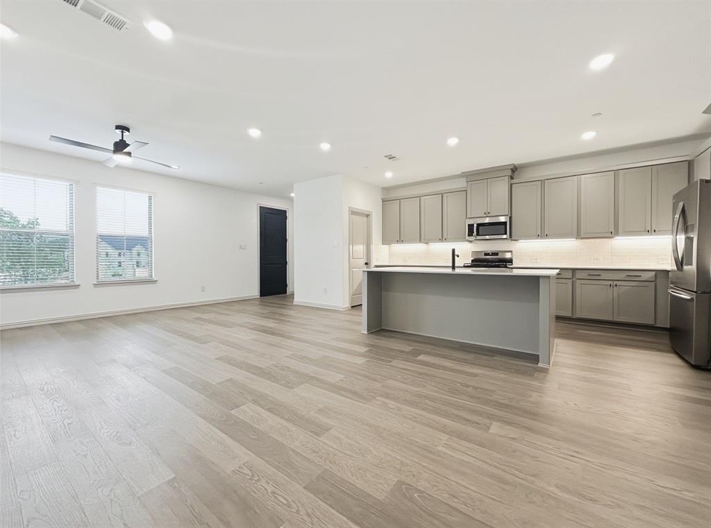 2837 Bluejack Road McKinney, TX 75071 - Photo 4 of 40 a view of kitchen with wooden floor and window