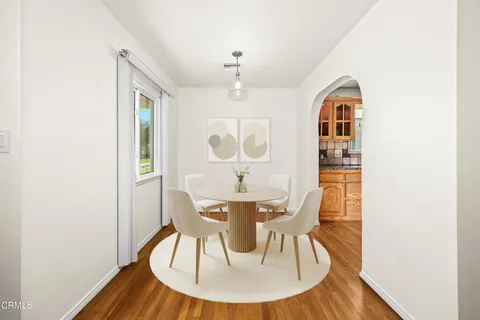 a view of a dining room with furniture and wooden floor