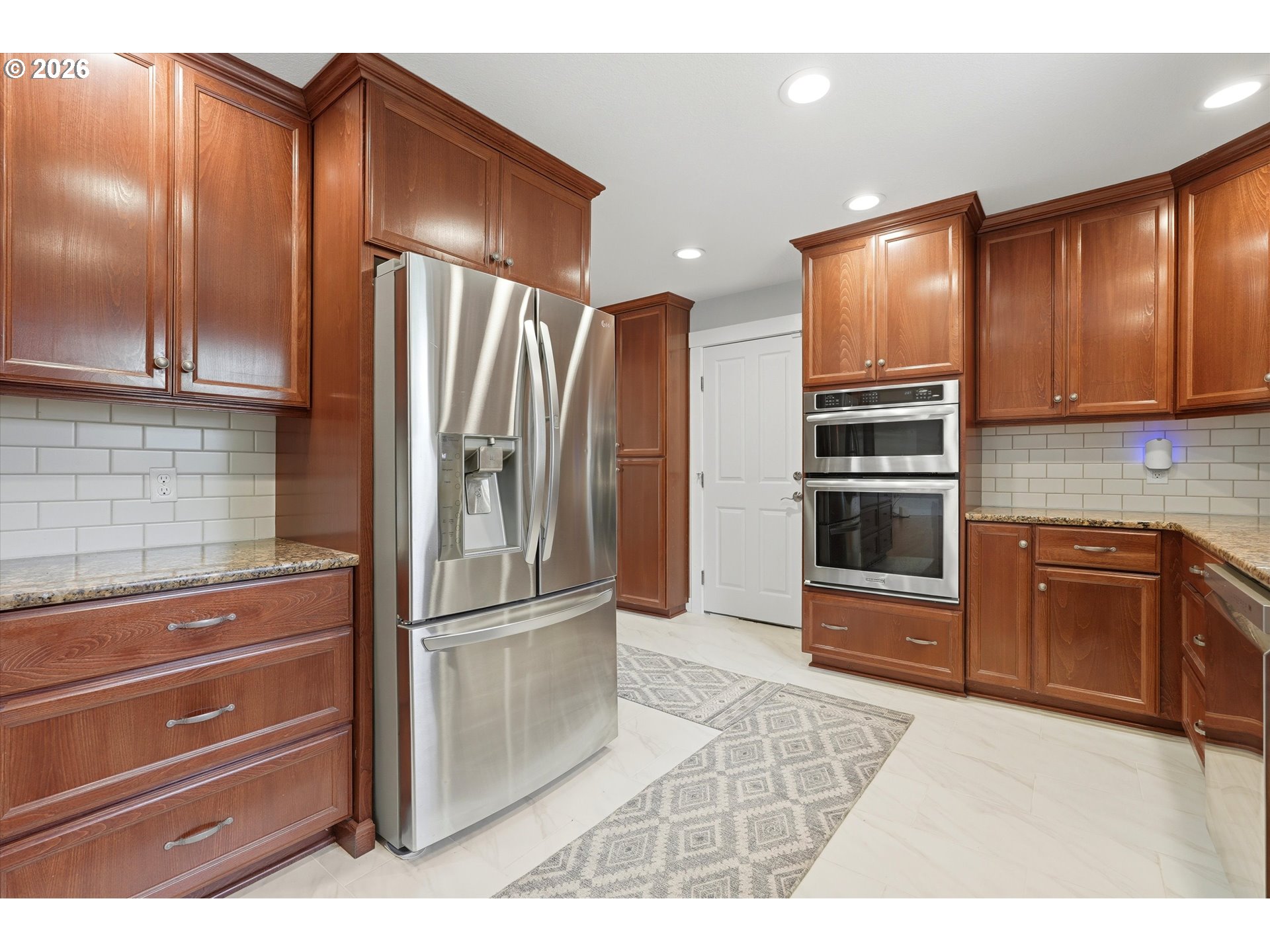 4621 Ohio Street Longview, WA 98632 - Photo 11 of 29 a kitchen with granite countertop wooden cabinets a refrigerator and a stove