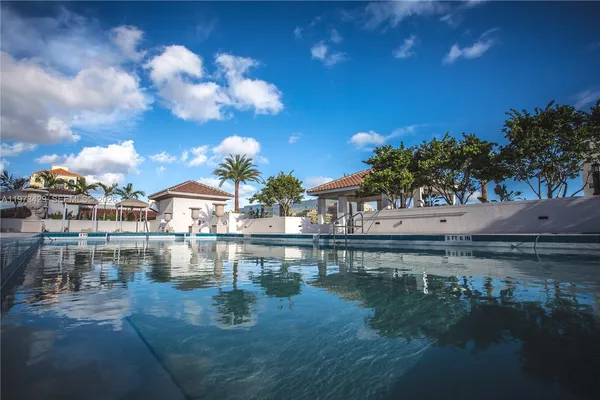 a view of swimming pool with outdoor seating and lake view