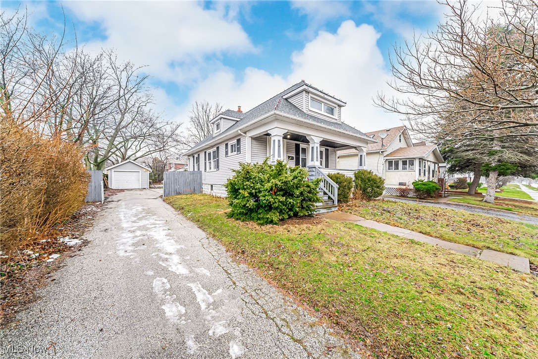 2014 Cook Avenue Cleveland, OH 44109 - Photo 2 of 37 Bungalow with an outbuilding, a garage, a front yard, and a porch