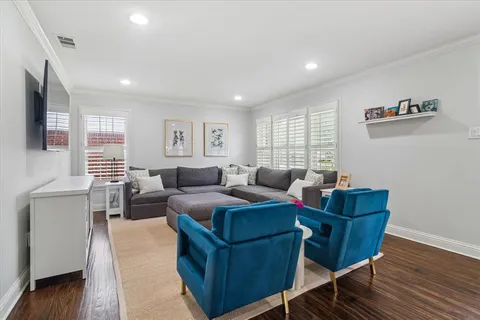 a living room with furniture and wooden floor