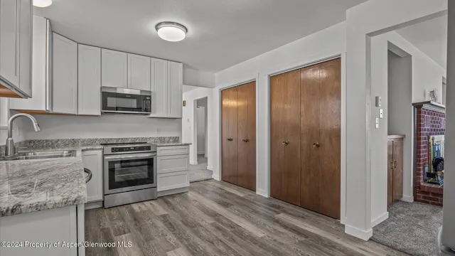 a kitchen with granite countertop a stove and a refrigerator