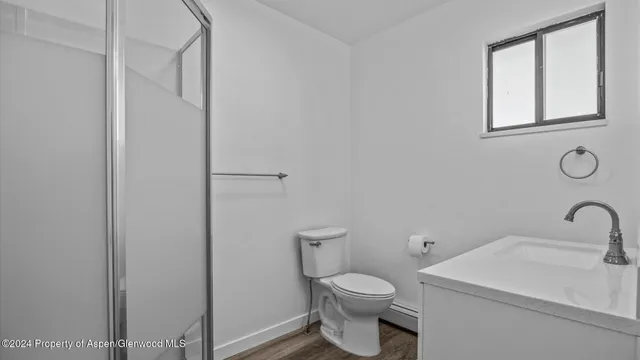 a white toilet sitting next to a bathroom sink