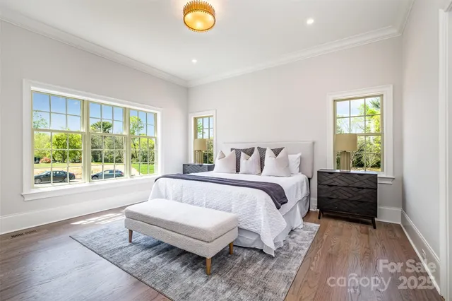 a spacious bedroom with a bed and a large window