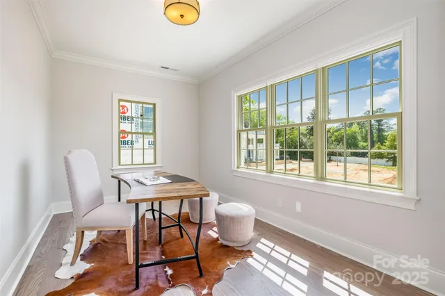 a view of a dining room with a table and chairs