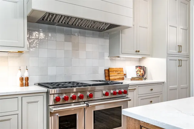a kitchen with stove and cabinets
