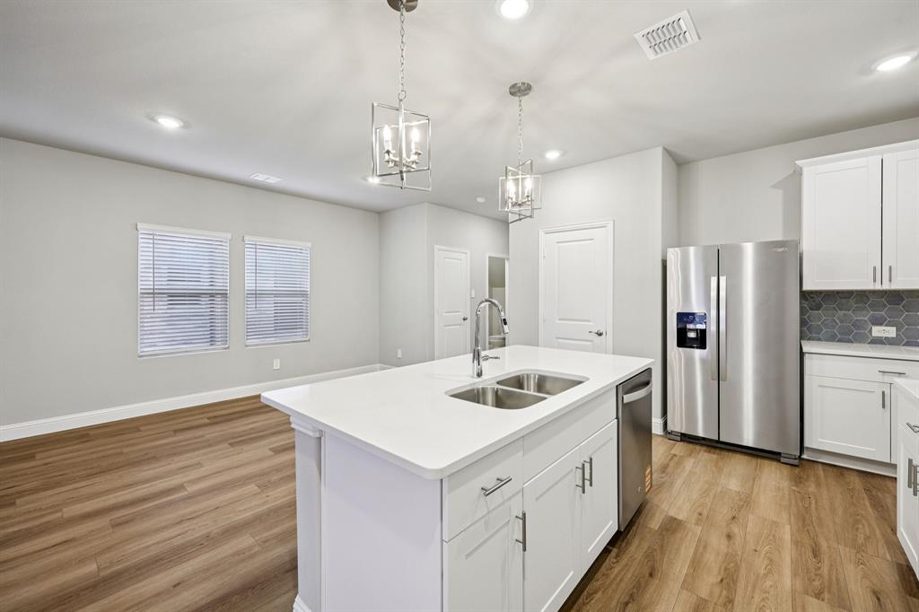 1721 Arches Road Anna, TX 75409 - Photo 15 of 39 a kitchen with stainless steel appliances granite countertop a sink stove and refrigerator