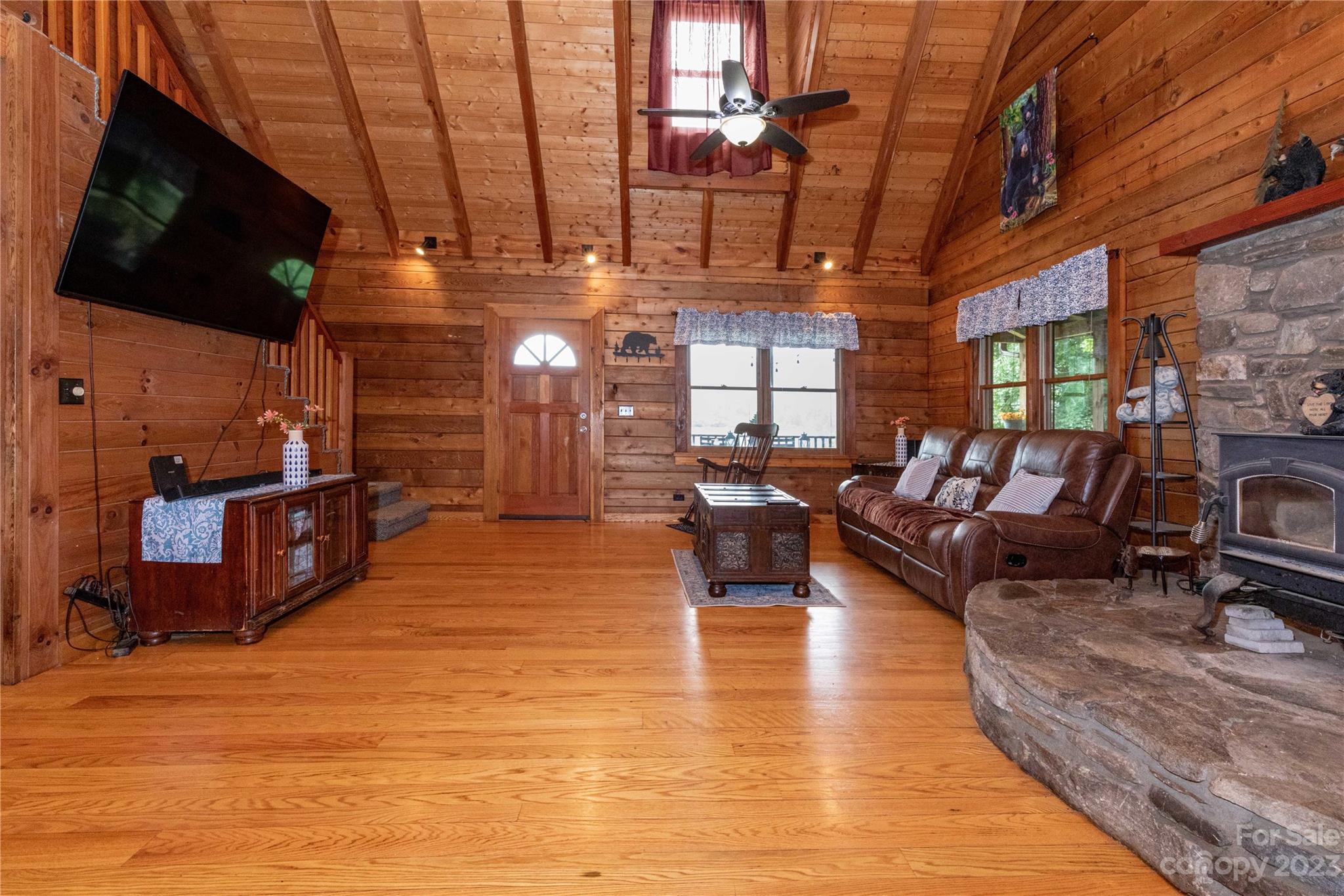 752 Upper Glady Fork Road Candler, NC 28715 - Photo 16 of 38 a living room with lots of furniture and a flat screen tv