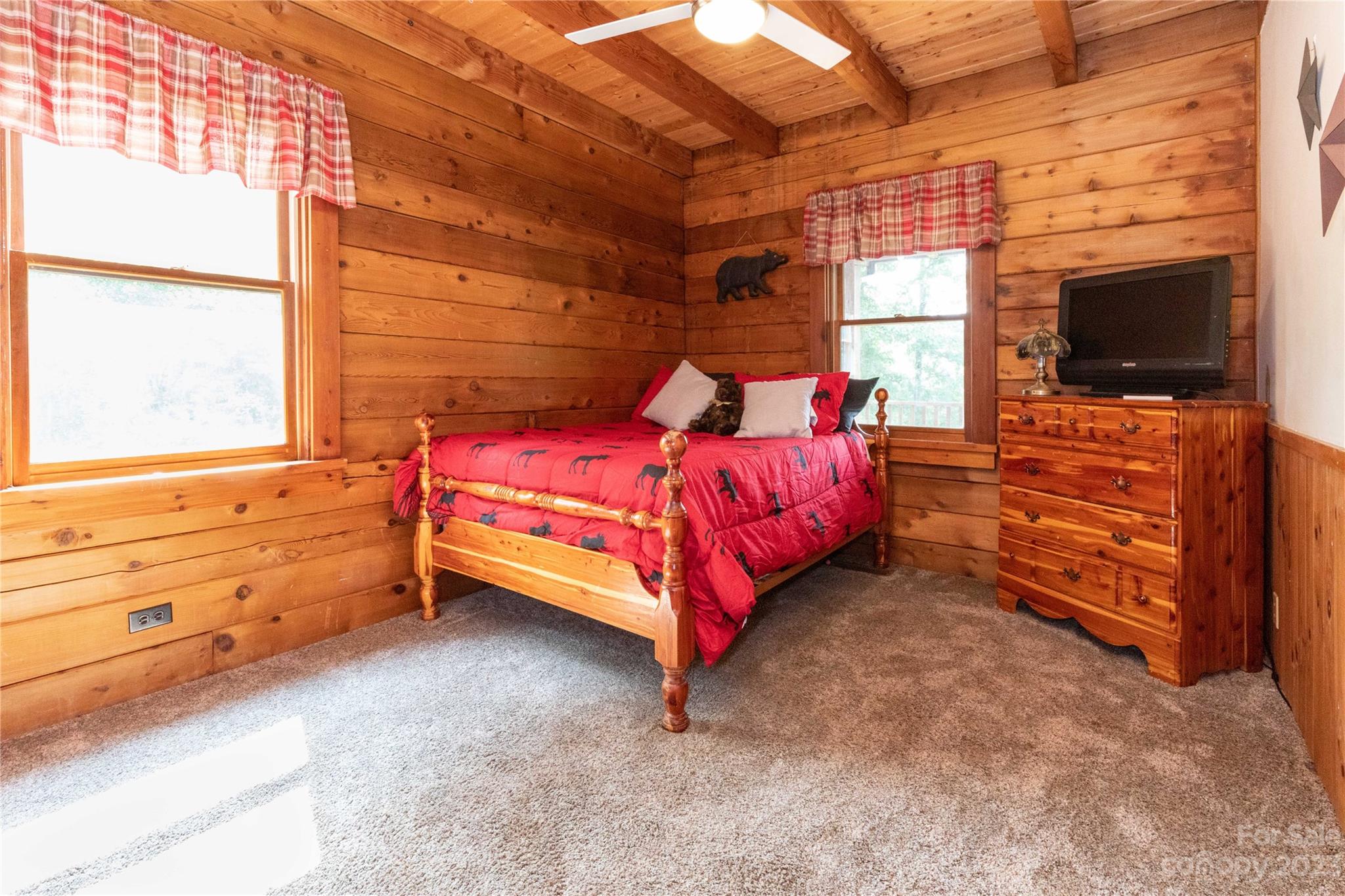 752 Upper Glady Fork Road Candler, NC 28715 - Photo 18 of 38 a bed room with a bed and a flat screen tv