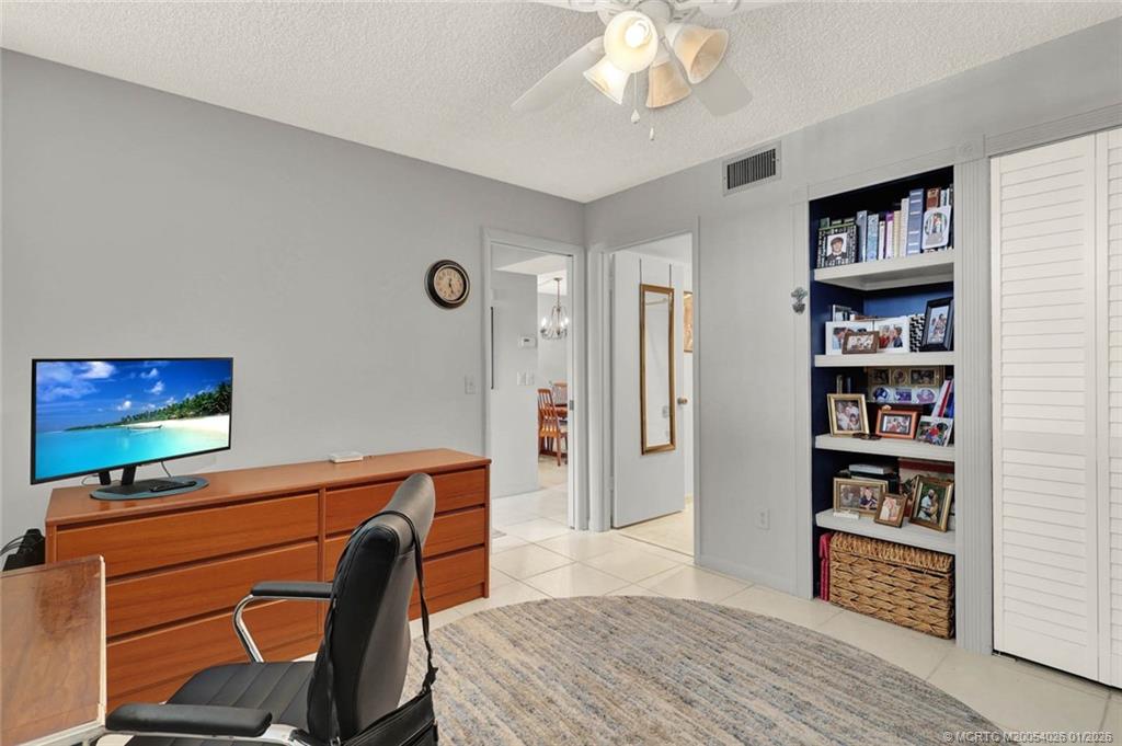 1950 Southwest Palm City Road, Unit 8106 Stuart, FL 34994 - Photo 33 of 54 a room with furniture a bookshelf and a window