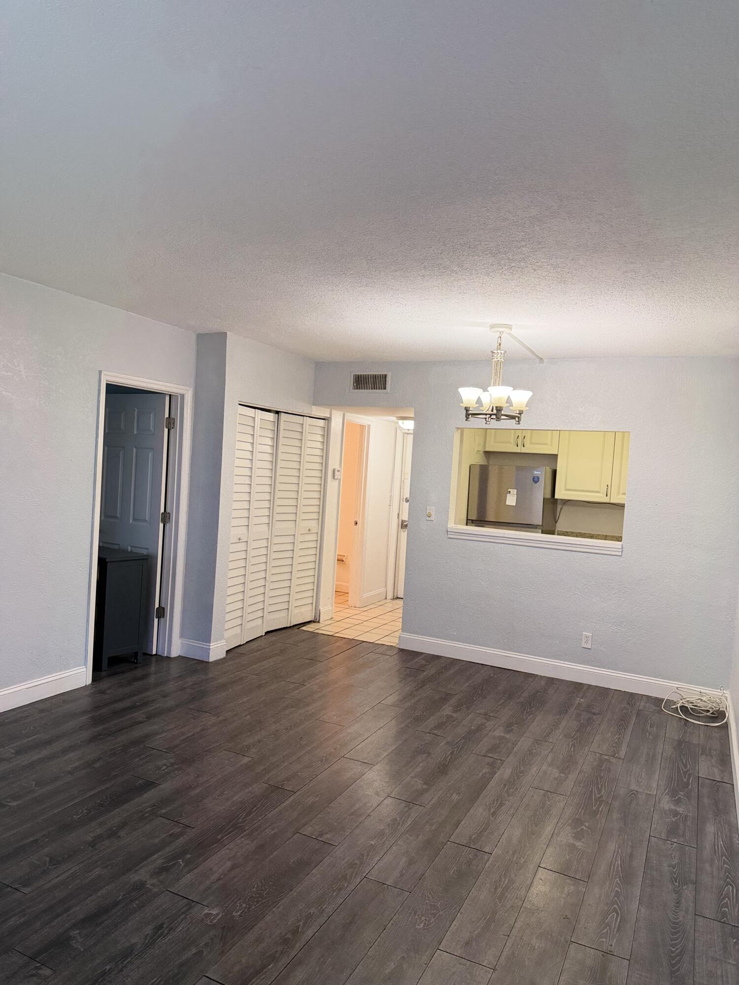 270 South Cypress Road, Unit 204 Pompano Beach, FL 33060 - Photo 3 of 14 a view of an empty room with wooden floor
