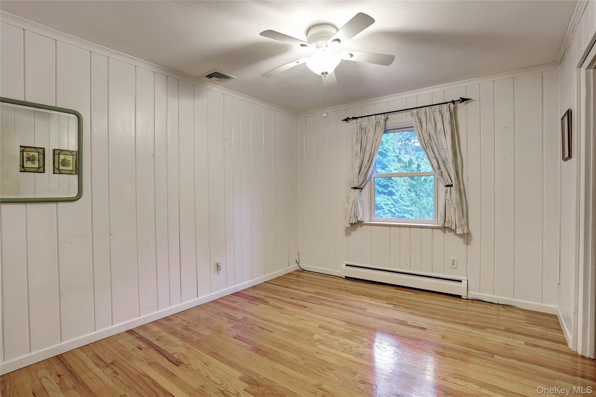 8 Swallow Avenue Spring Valley, NY 10977 - Photo 16 of 28 an empty room with wooden floor chandelier fan and windows