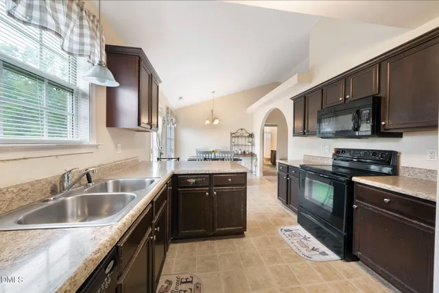 a kitchen with stainless steel appliances granite countertop a sink and stove