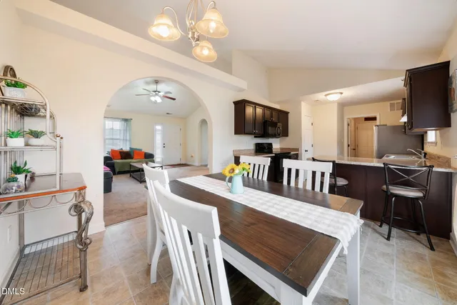 a view of a dining room with furniture and a flat screen tv