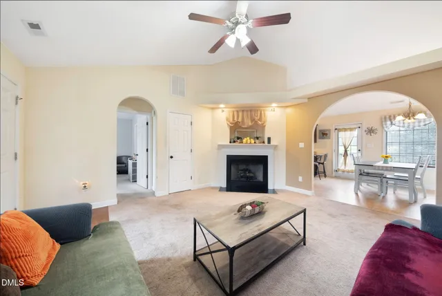 a living room with furniture and a fireplace