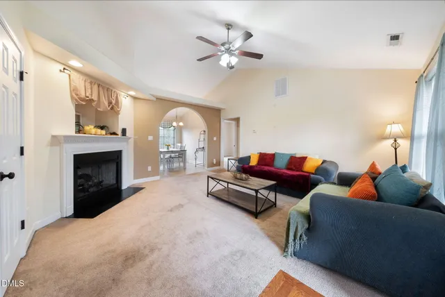 a living room with furniture and a fireplace